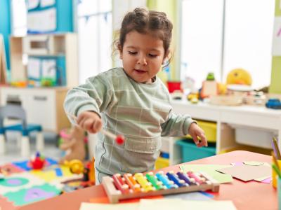 child with toy xylophone