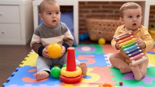 two babies playing