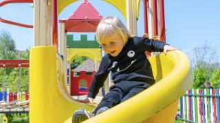 boy going down slide