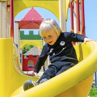 boy going down slide