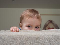 child behind couch