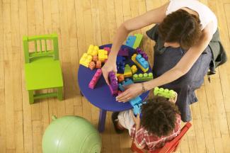 teacher and student playing with blocks