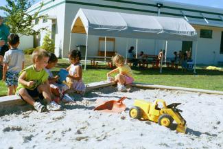  children playing in sandbox