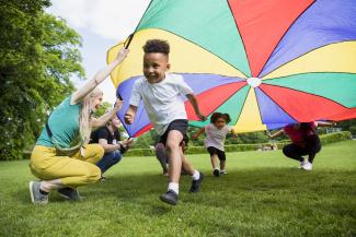 boy playing under tent