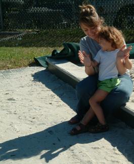 teacher and child at sandbox