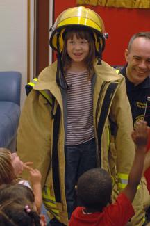 student in fire fighter suit