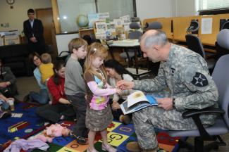 military personnel reading to students