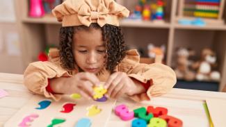 child playing with number blocks 